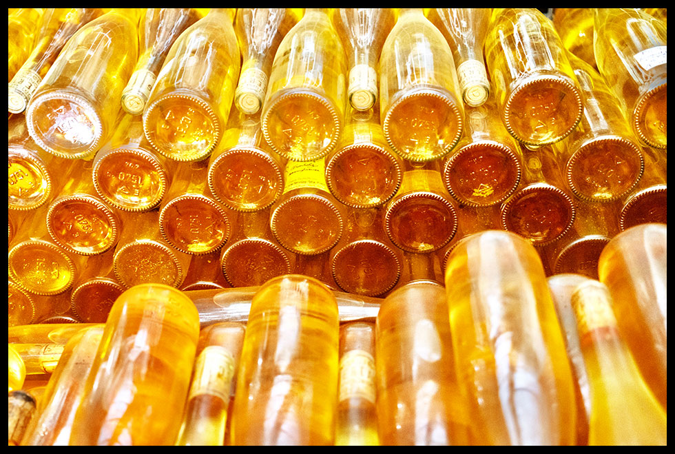 Image of stacked golden white wine botles